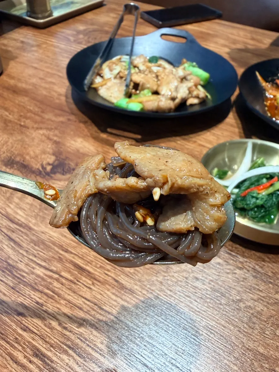 Table spread with spicy gochujang pork belly and naengmyeon