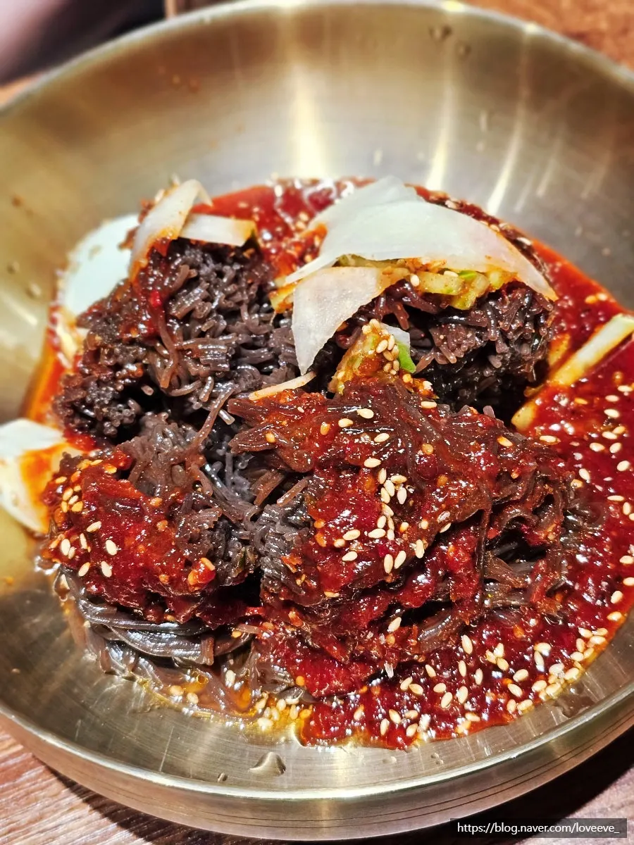 Table spread with soy-glazed pork belly and naengmyeon