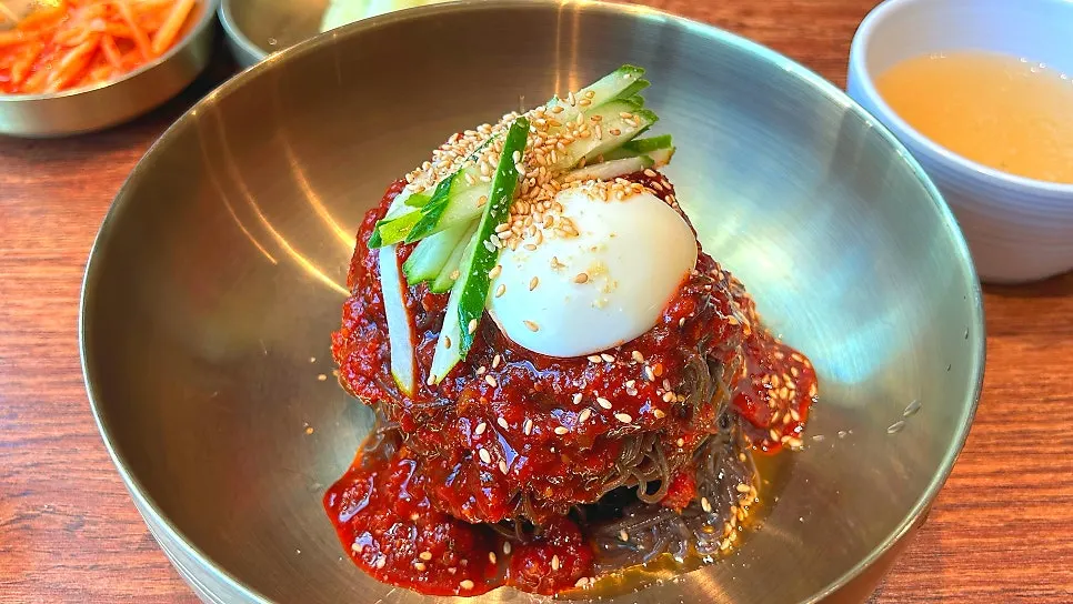 Bowl of mul-naengmyeon with the signature broth