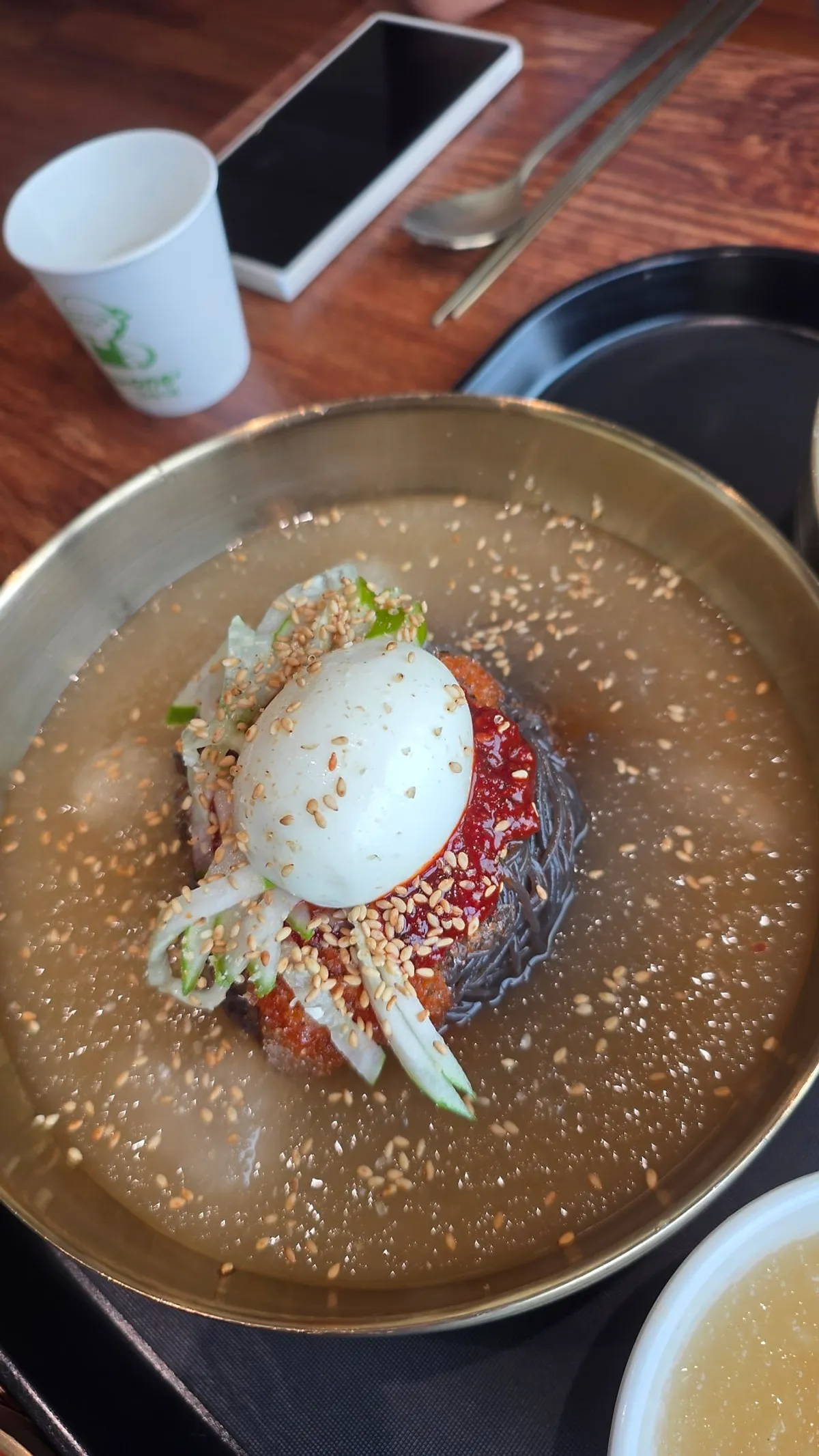 Chewy kudzu noodles lifted up with chopsticks