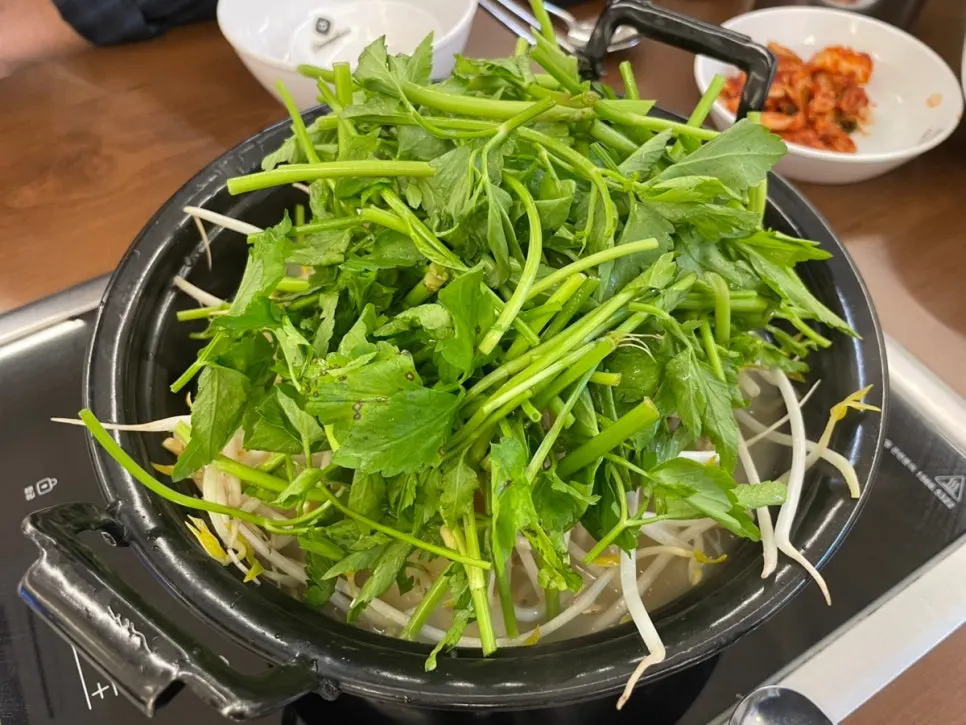 Pot of mushroom shabu packed with minari