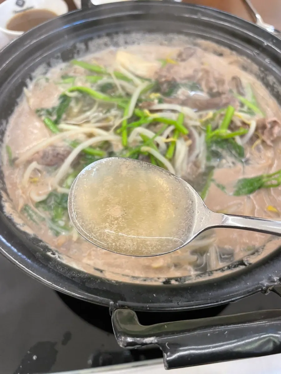 A bowl of clear broth shabu-shabu