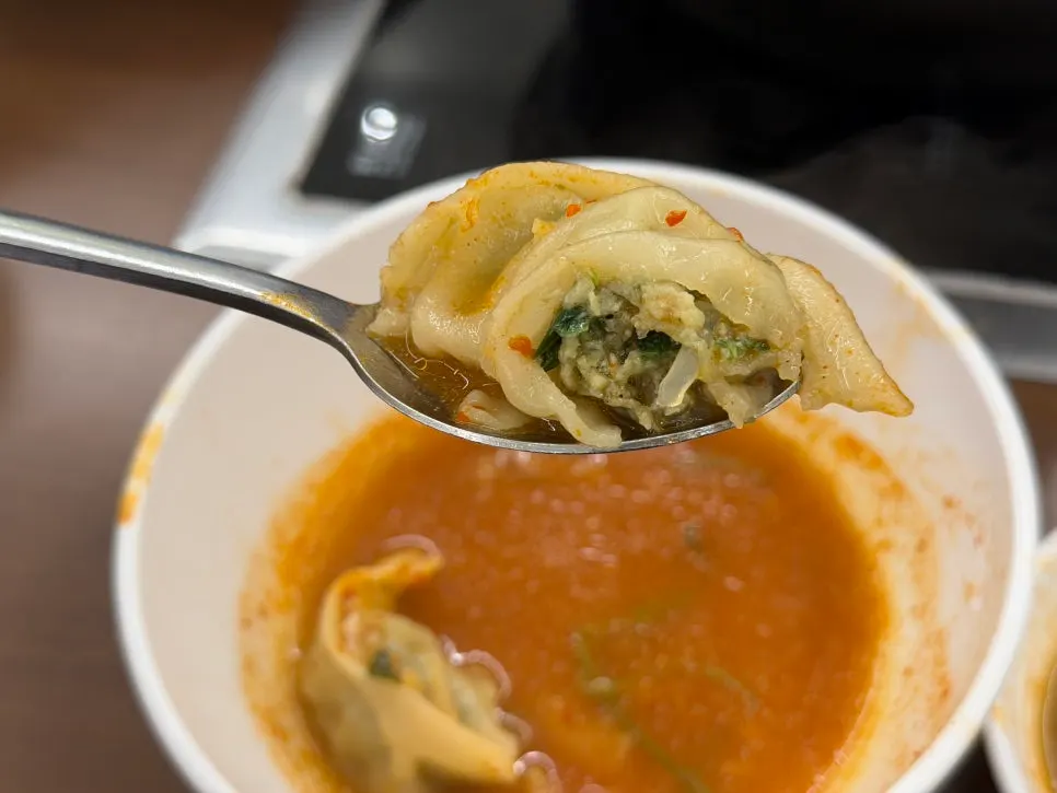 A single dumpling scooped out to eat