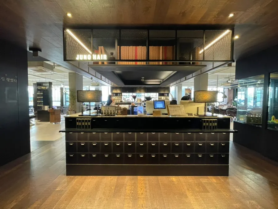 Salon interior opening straight off the elevator with the central checkout counter