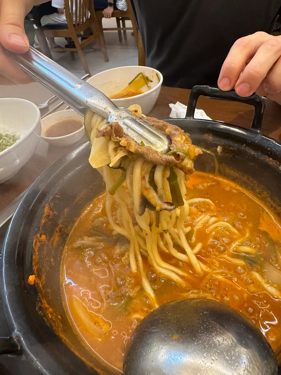Kalguksu noodles added and simmered in the thickened broth