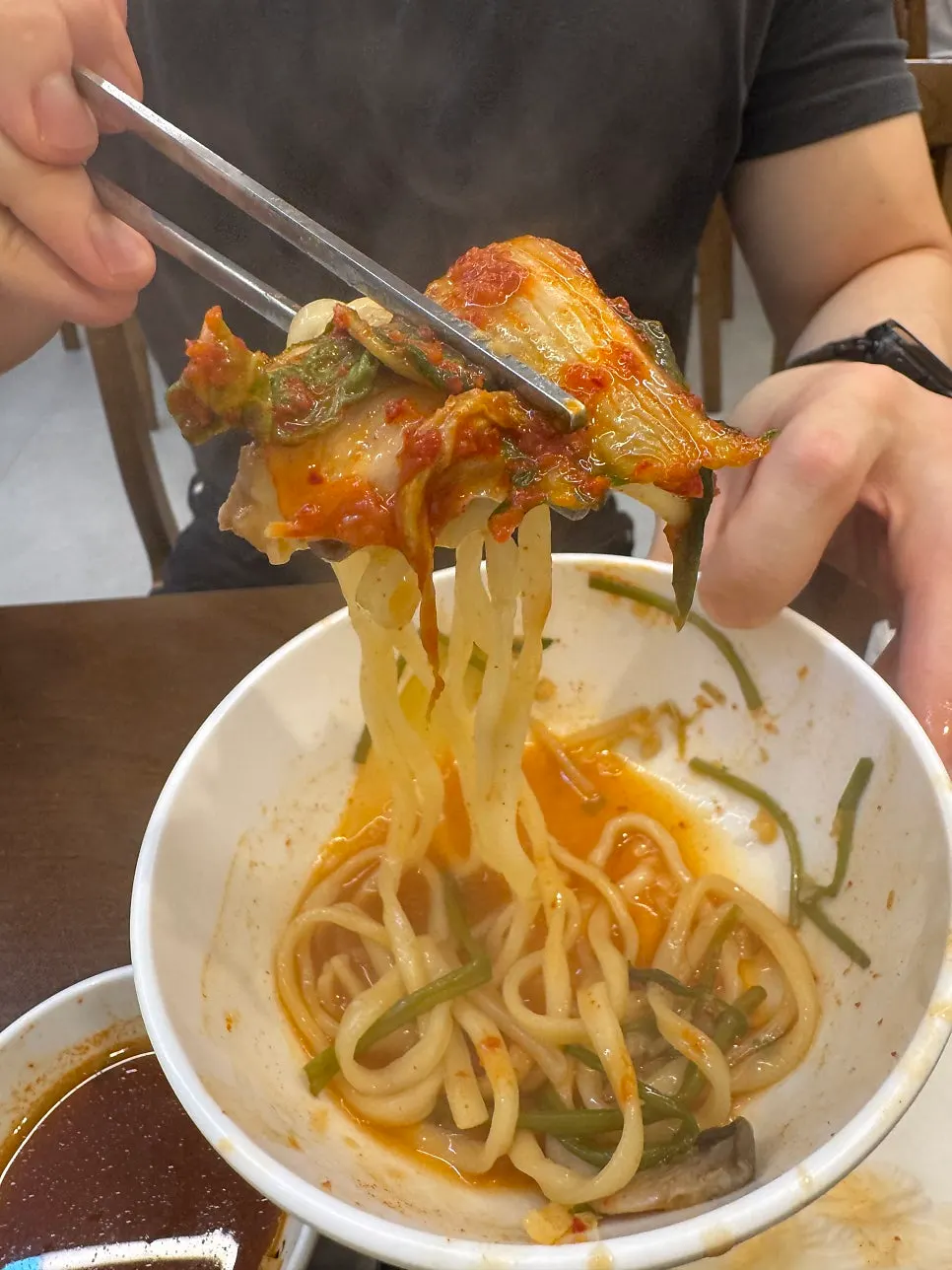 Kalguksu noodles added and simmered in the thickened broth