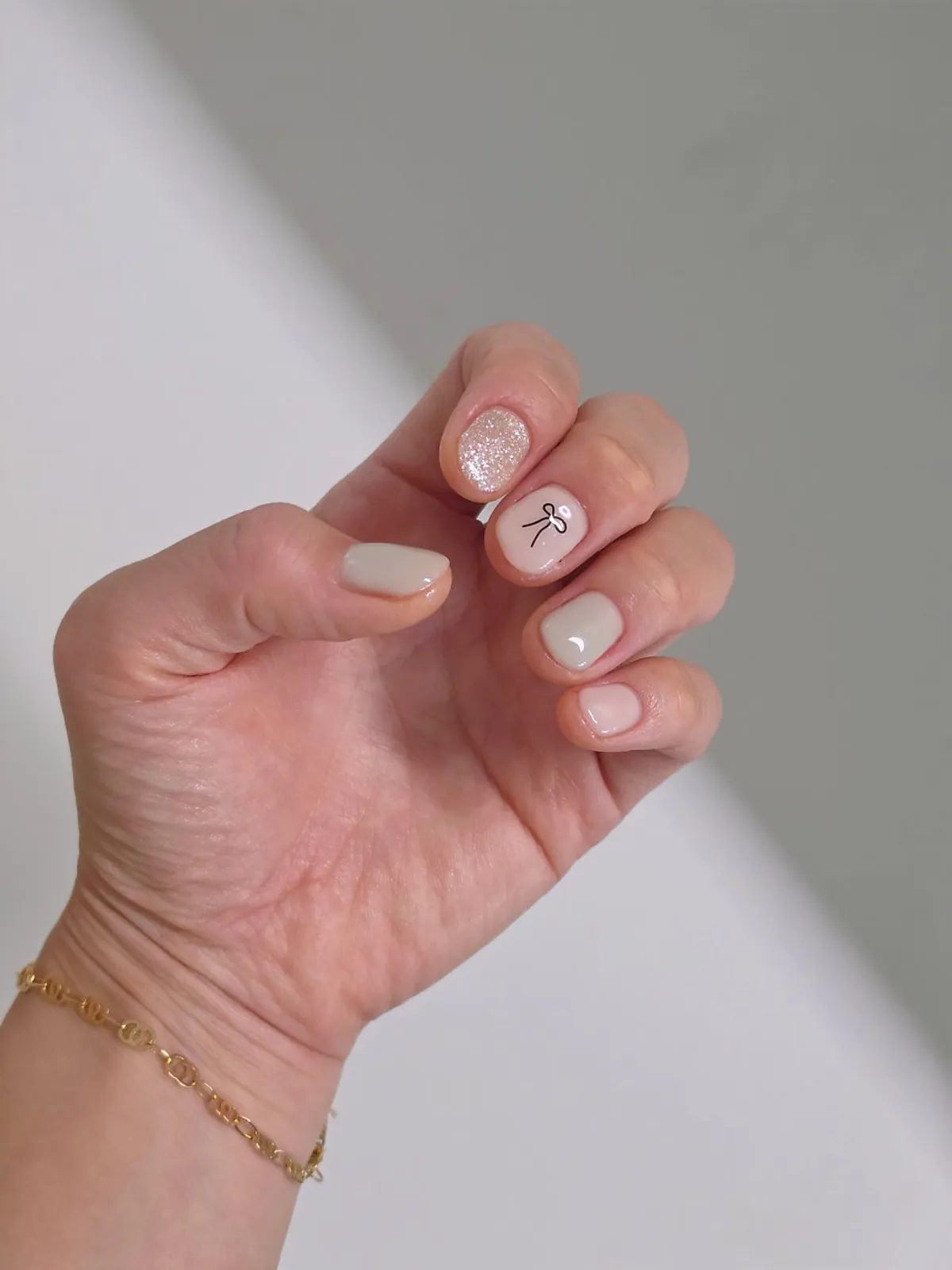 Mint gel nails with pearl and ribbon accents