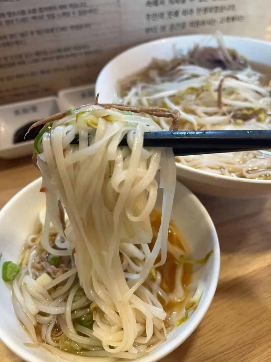 Enjoying pho broth and noodles together