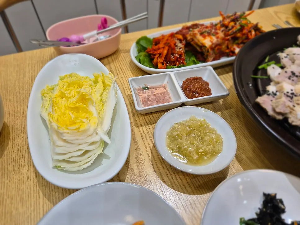 A piece of bossam with garlic sauce