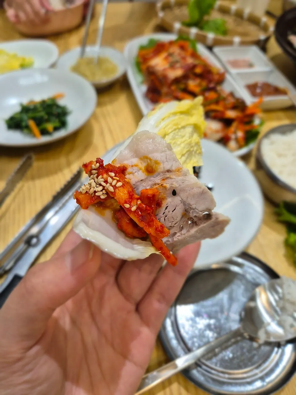 Wrapping up a bite of garlic bossam