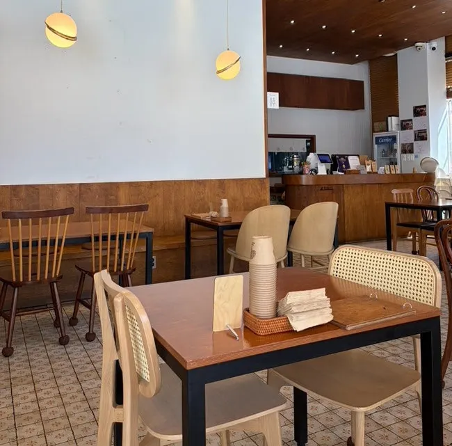Dining hall with 4-top tables at Kkot Gatsu