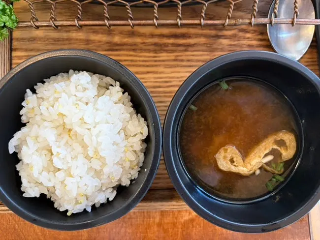 Rice and soup served alongside the cheese cutlet