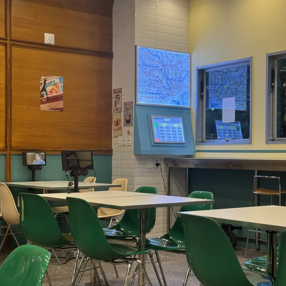 Green chairs, white table, and tablet ordering device
