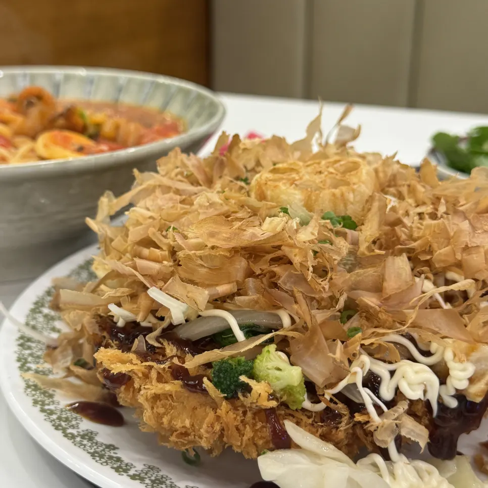 Okonomiyaki pork cutlet topped with sauce and toppings