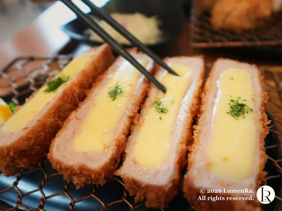 A piece of cheese cutlet showing the meat-to-cheese ratio