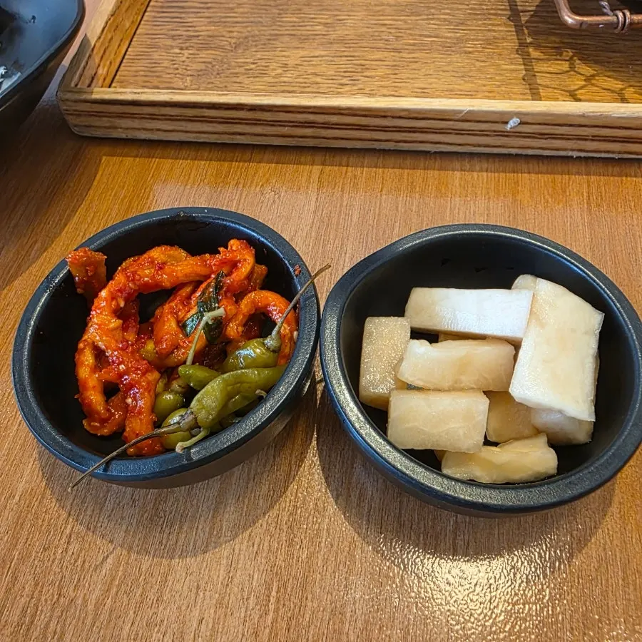 Dried radish salad and pickles on a small plate