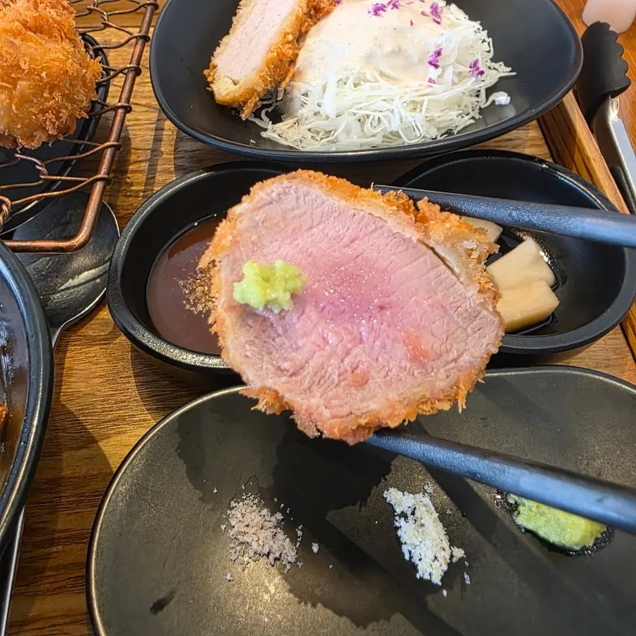 A piece of flower cutlet topped with wasabi