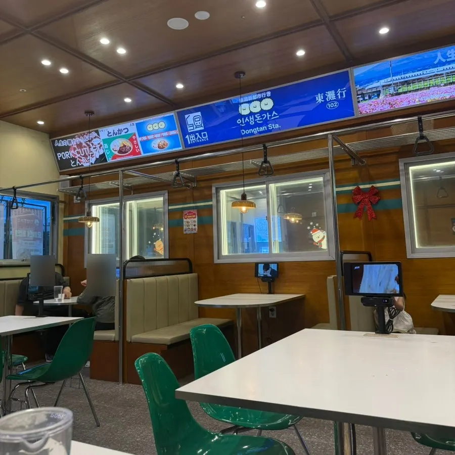 Exterior with subway station sign and red chairs