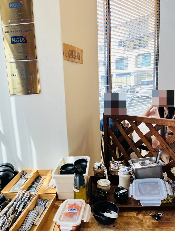 Sauces and utensils at the Kkot Gatsu self-serve bar