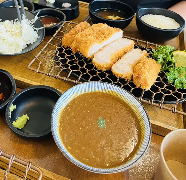 Close-up of cutlet with accompanying sauces