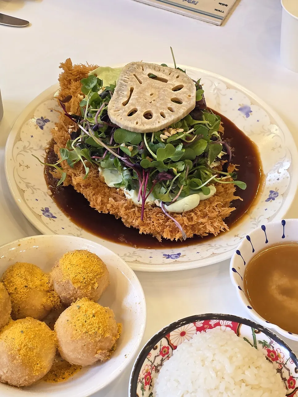 Wasabi cream cheese pork cutlet topped with baby greens and lotus root chips