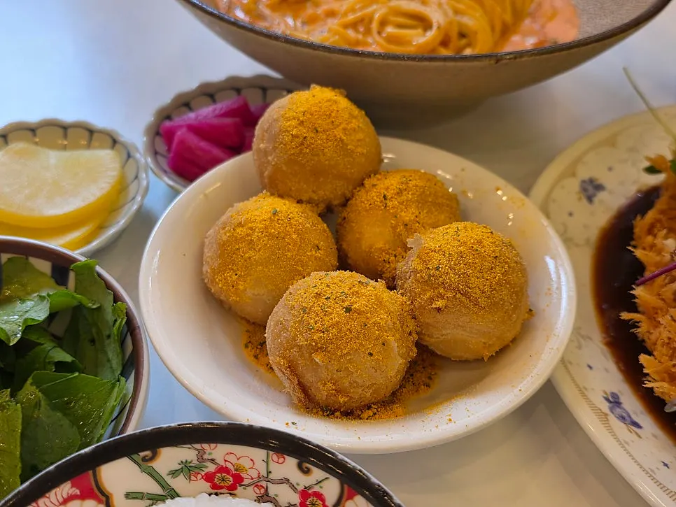 Five ppuring cheese balls coated in cheese seasoning