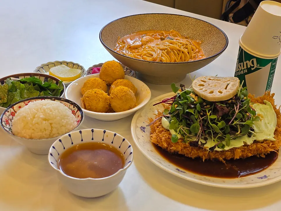 Table with pork cutlet, pasta, and cheese balls together