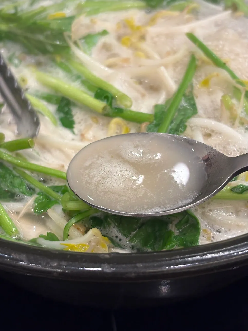 Close-up of the mild clear broth shabu hot pot