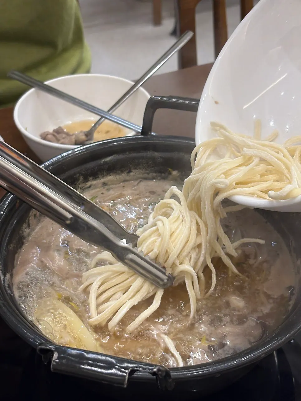Kalguksu noodles simmering in the broth