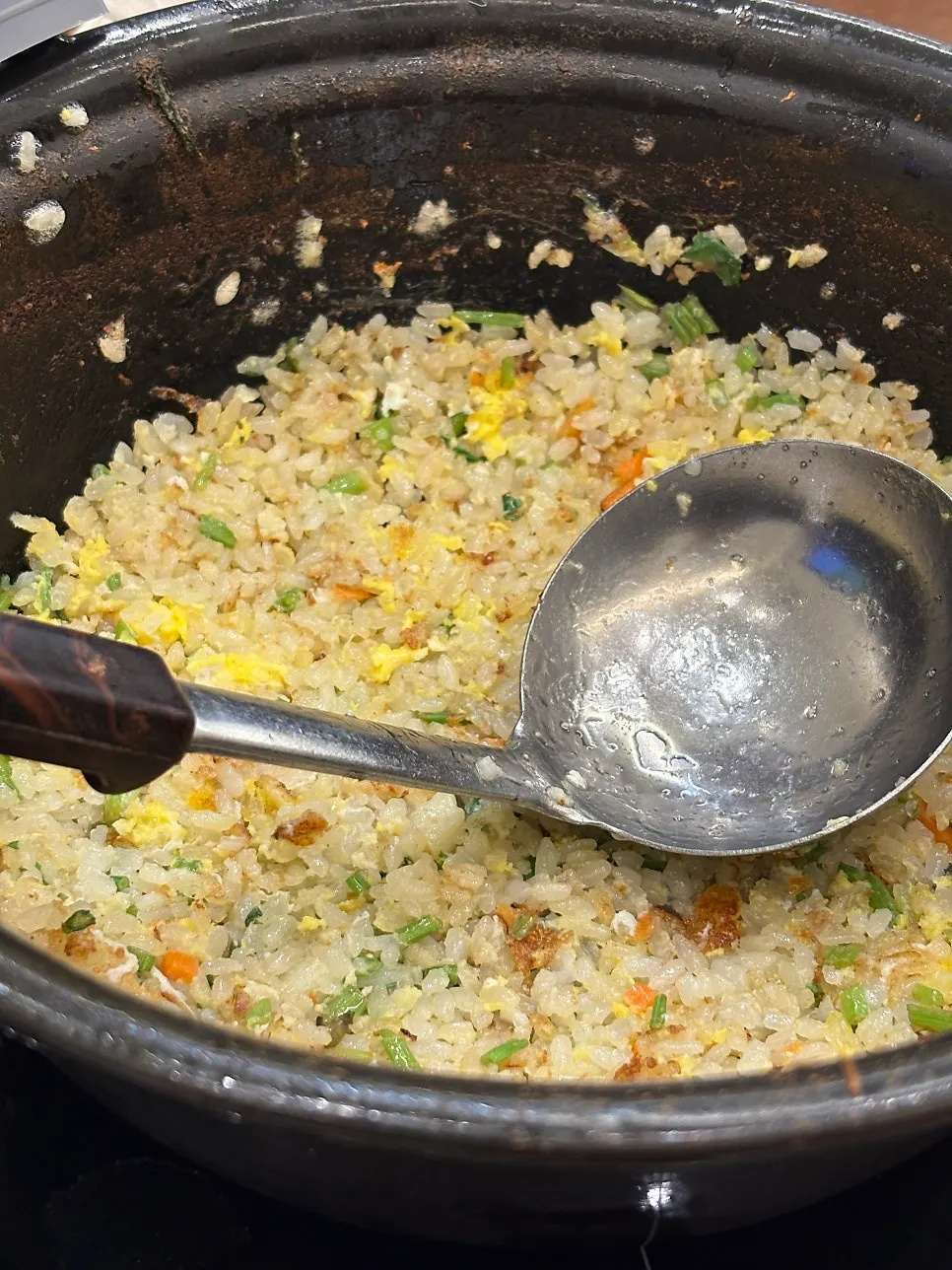 Egg vegetable fried rice being stir-fried at the end of the meal