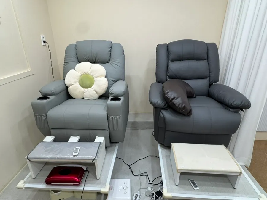 Plush chairs in the pedicure area inside Green Nail