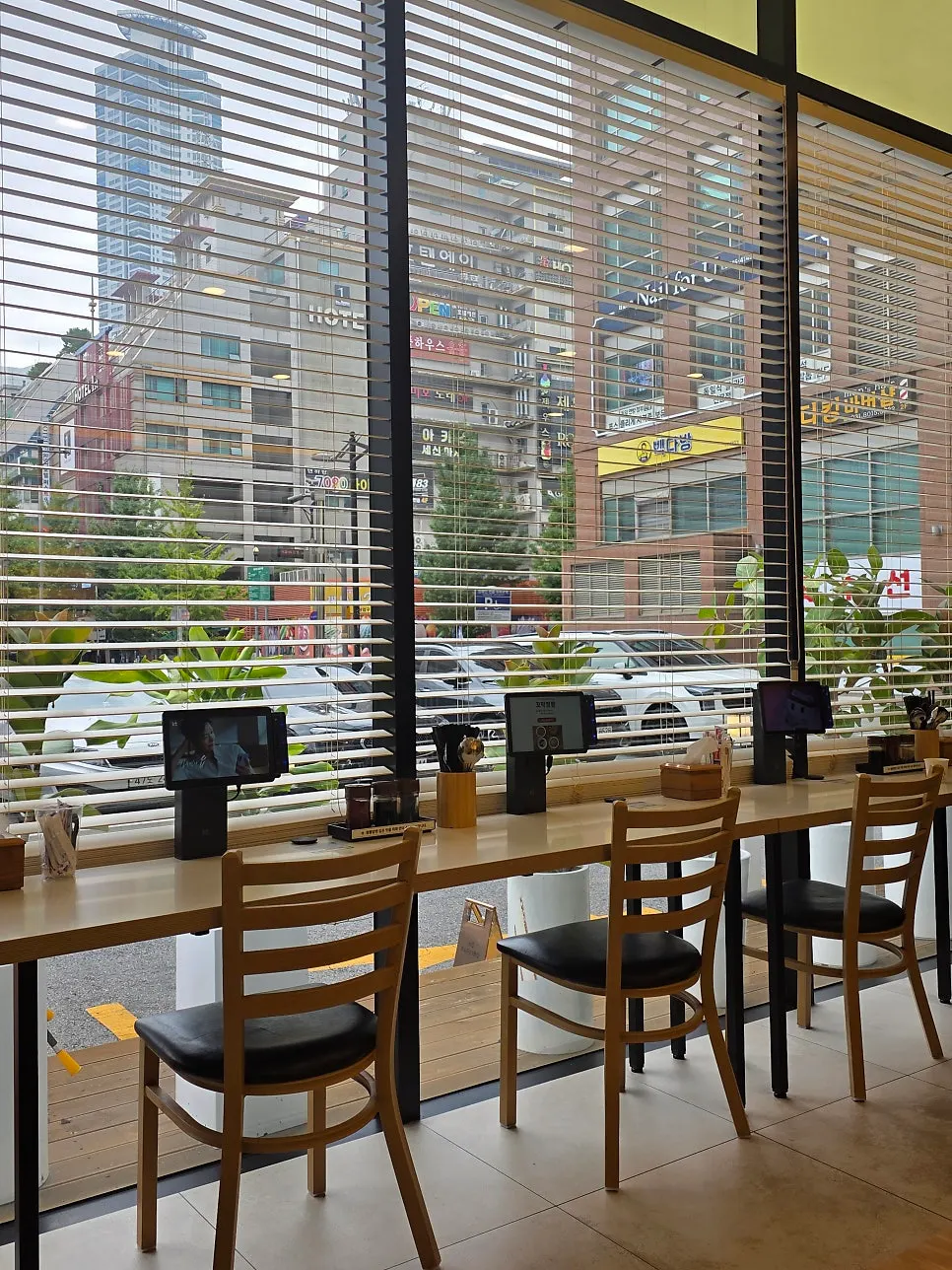 Interior with wood-toned tables and sofa-style seating