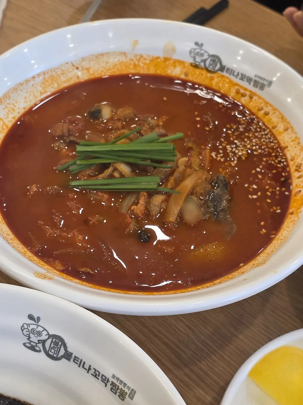Table set with cockle jjamppong rice, jajangmyeon, and tangsuyuk