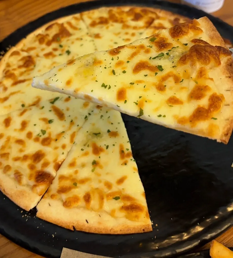 A slice of thin-crust gorgonzola pizza