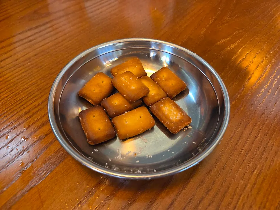 Sugar-dusted fried crackers served as the free side snack