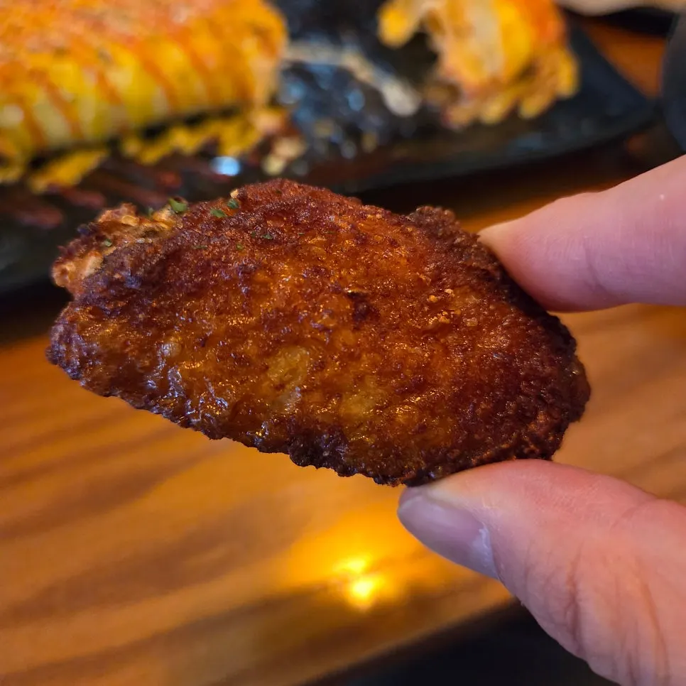 Chicken wings and drumettes coated in red sauce