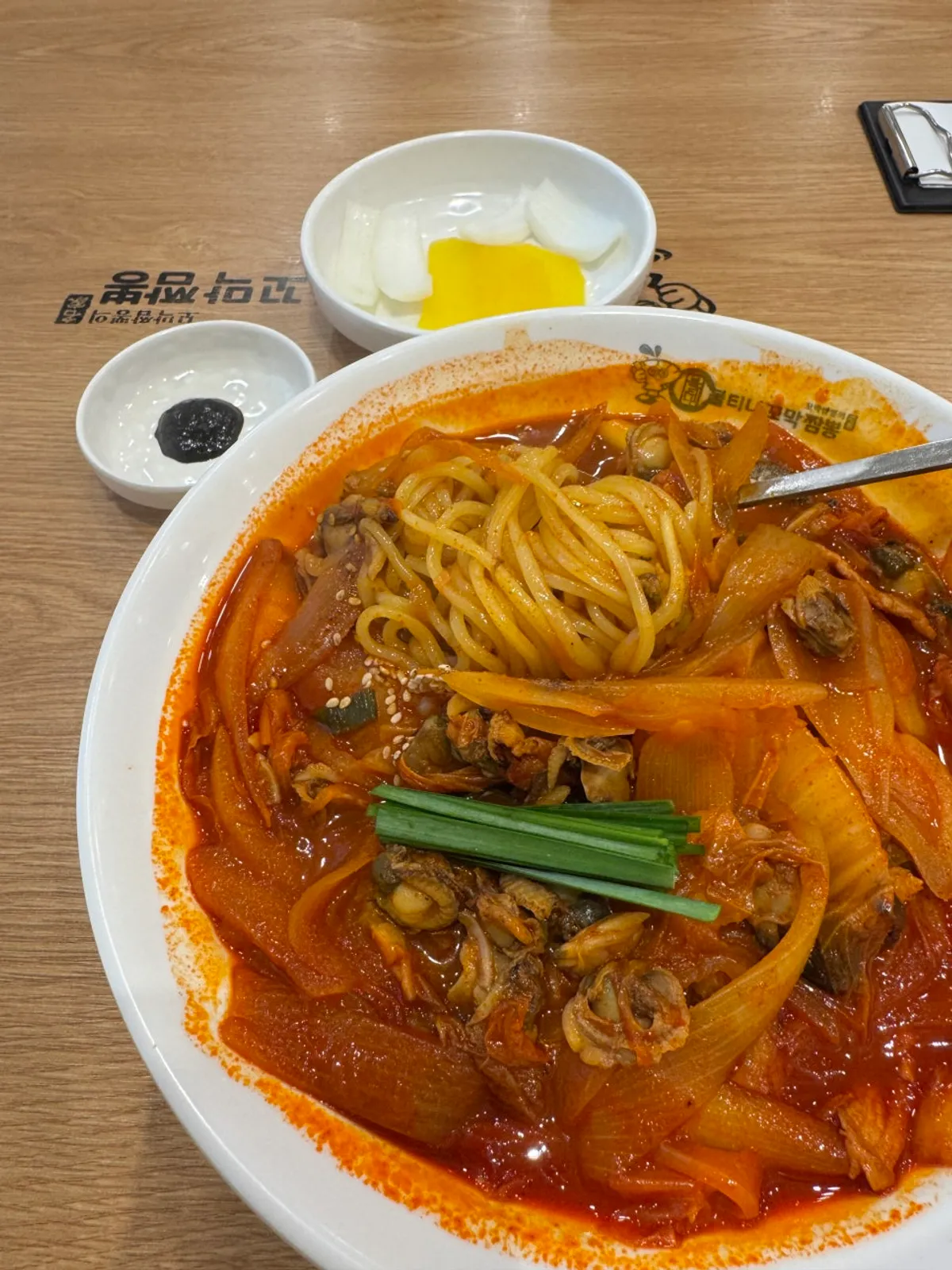 A bowl of cockle jjamppong piled high with cockles