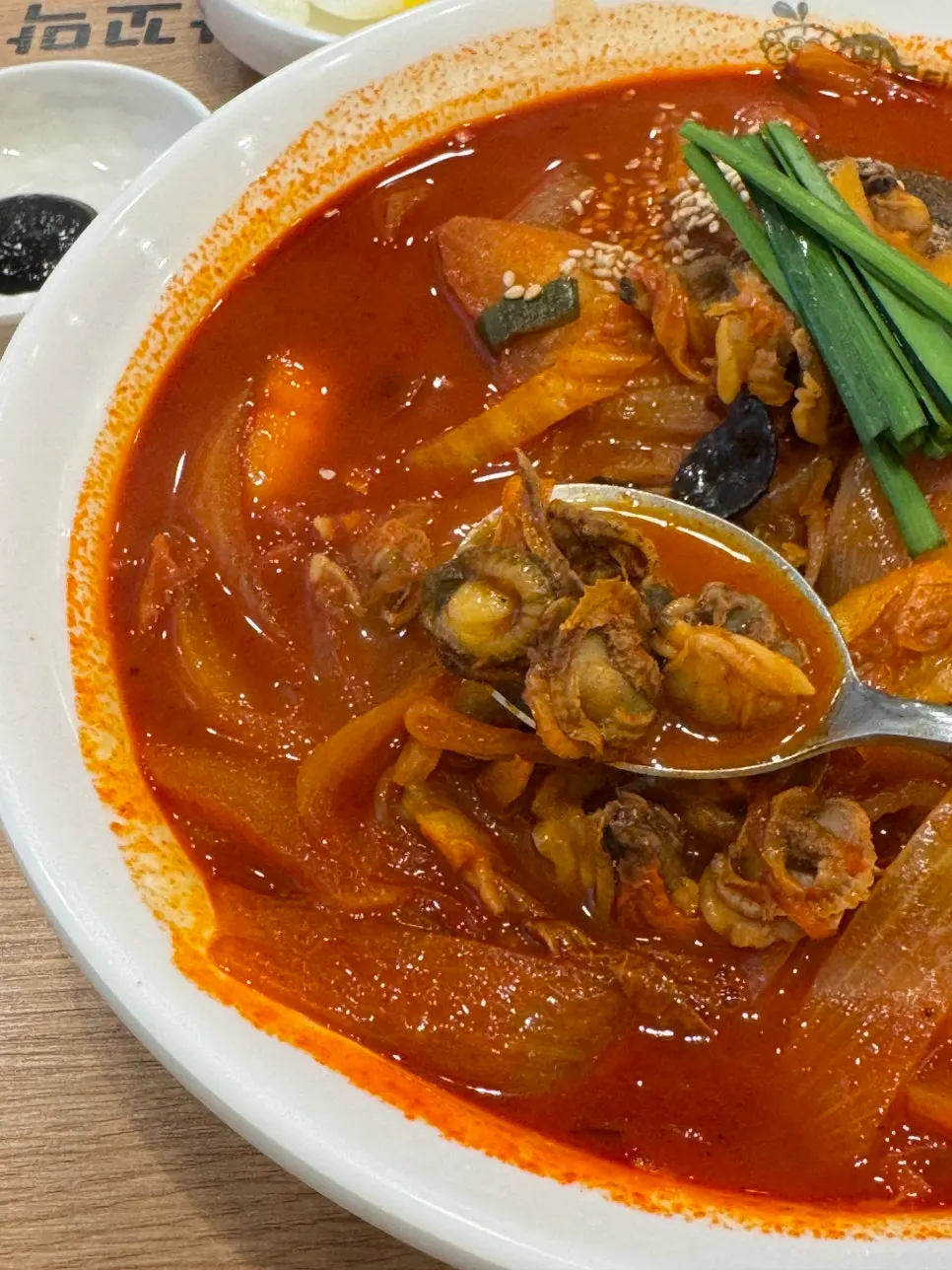 Close-up of the red cockle jjamppong broth and noodles