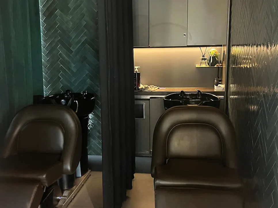 Spacious shampoo room with calm lighting