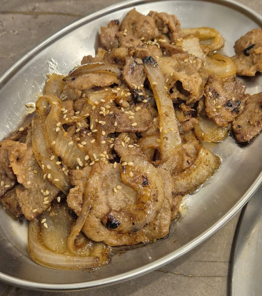 A pan of duruchigi topped with plenty of sauce