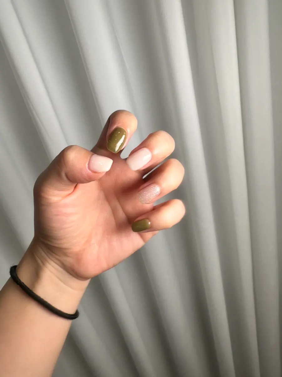 Finished white-and-olive gel nails