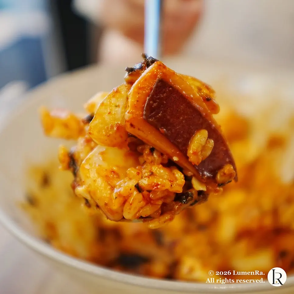 A spoonful of squid and seasoned rice