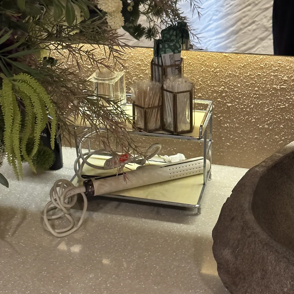 Restroom with flower arrangements and lighting