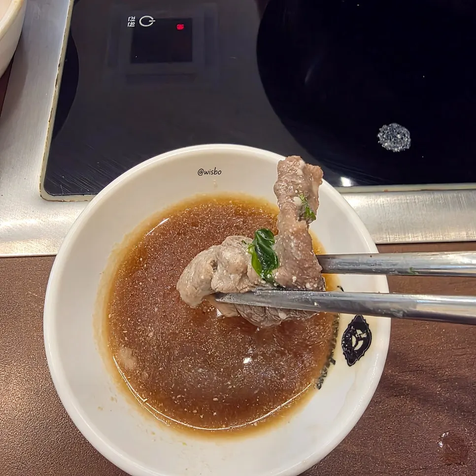 A plate of shabu-shabu served with vegetables
