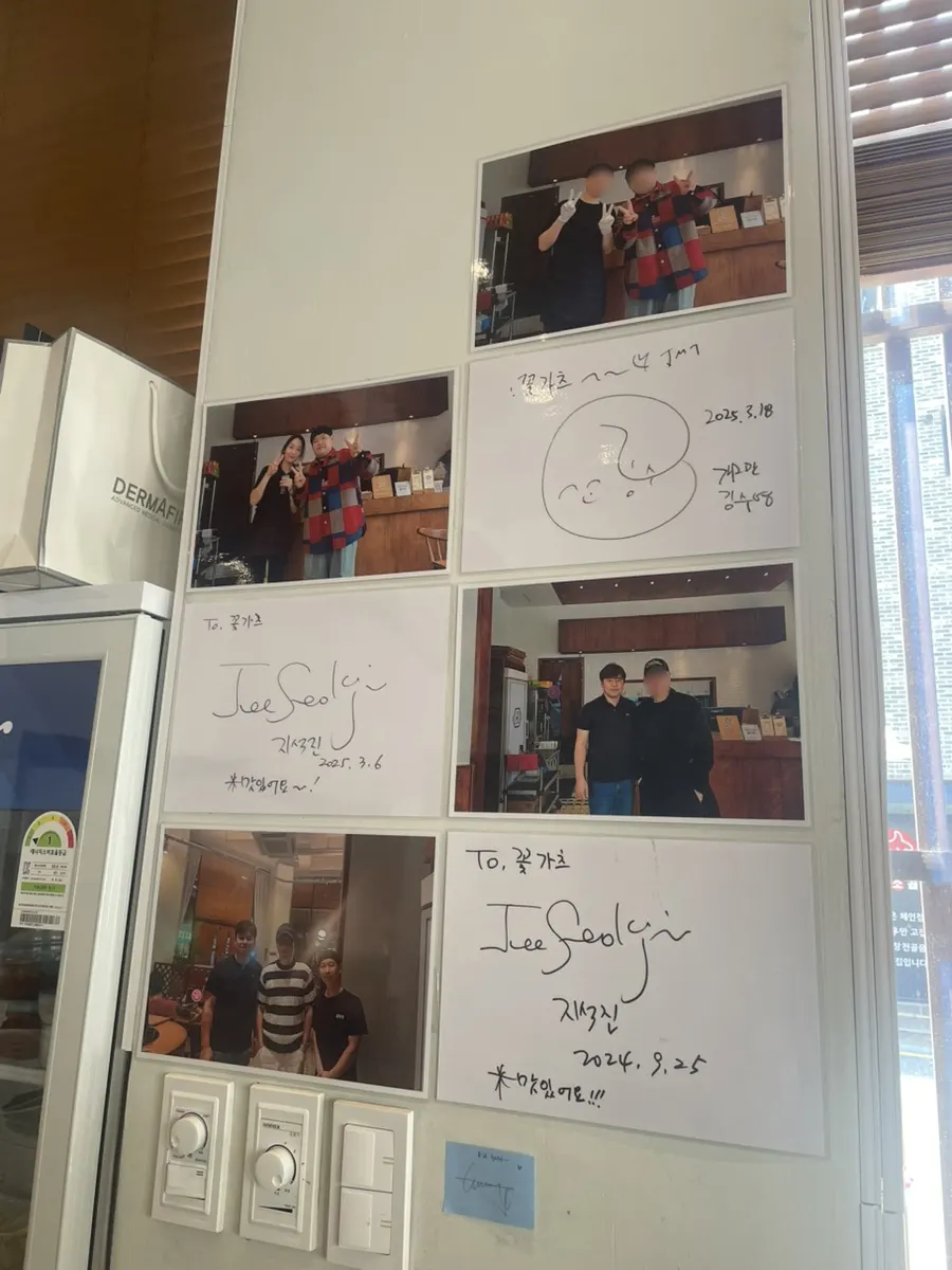 Wall of visitor photos and signatures
