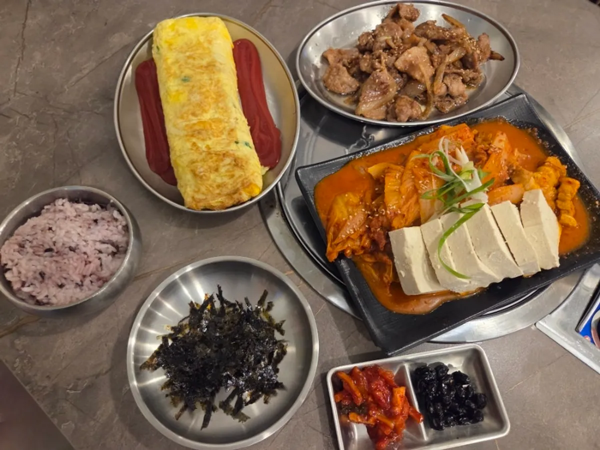 Full spread of pork kimchi braise, rolled omelet, and soy sauce bulgogi