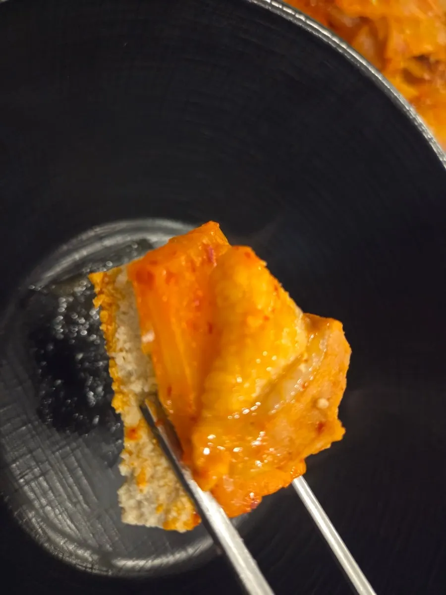 Three-part bite of tofu, kimchi, and pork belly