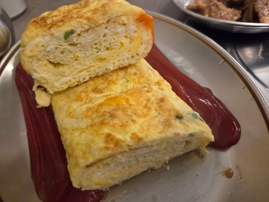 Thick rolled omelet served with ketchup
