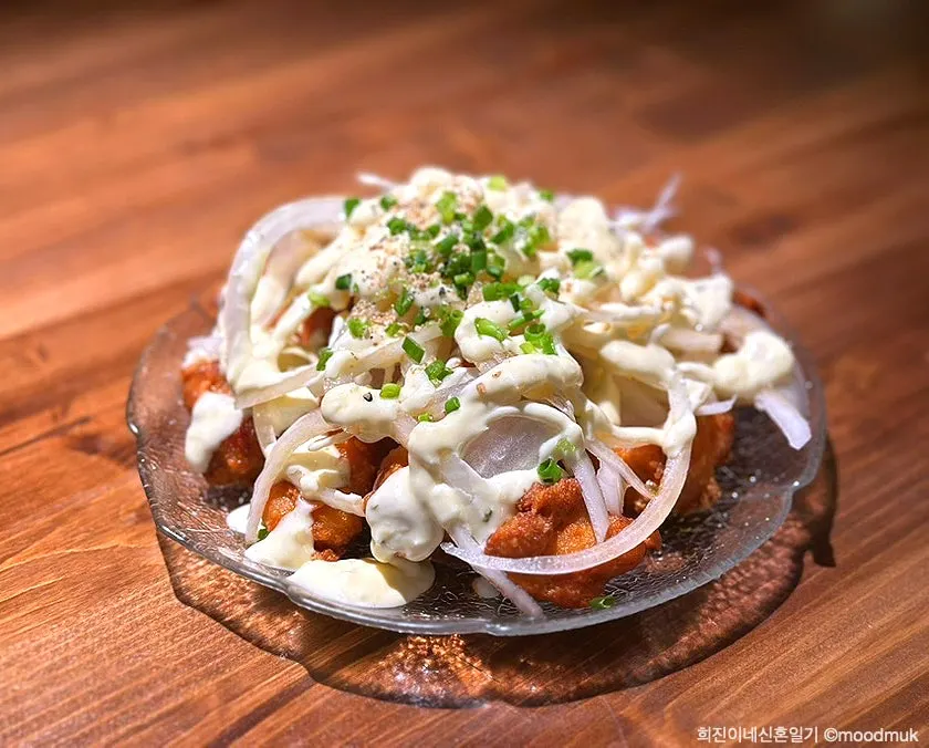 Plate of chicken nanban topped with onion and green onion