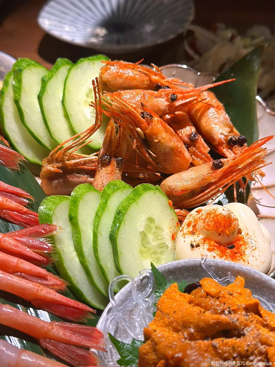 Full table spread of sweet shrimp and uni